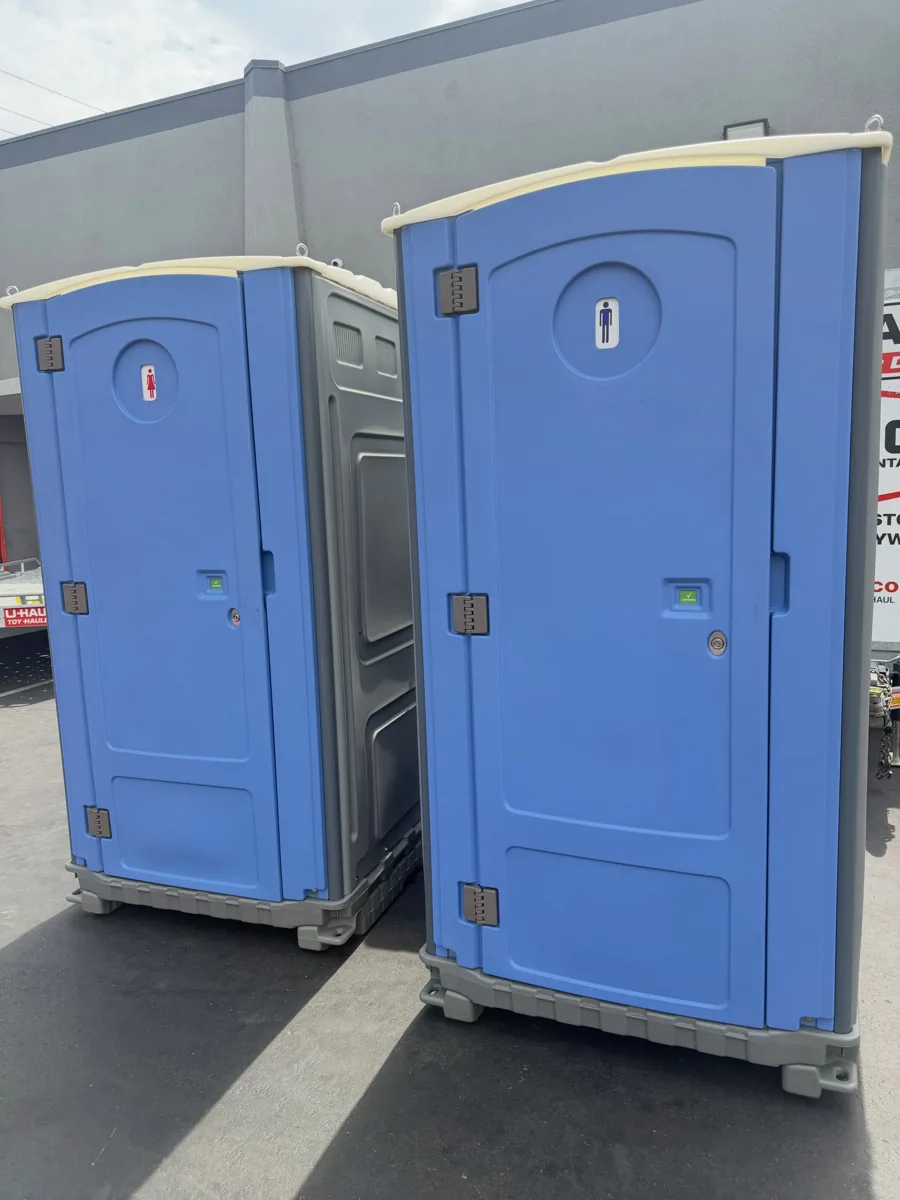 Two blue portable restrooms shown side by side
