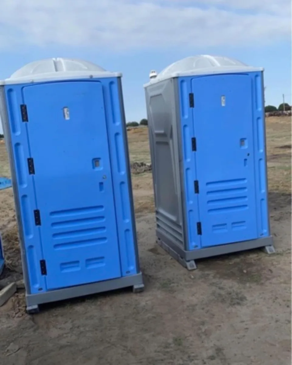 Two blue standard portable toilet units
